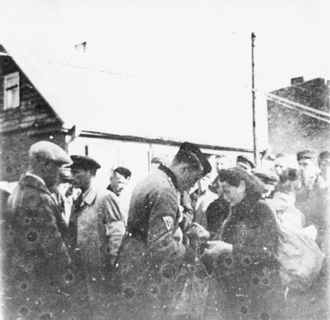 Kovno workers are searched by ghetto police at the Krisciukaicio Street entrance upon their return from forced labor outside the ghetto